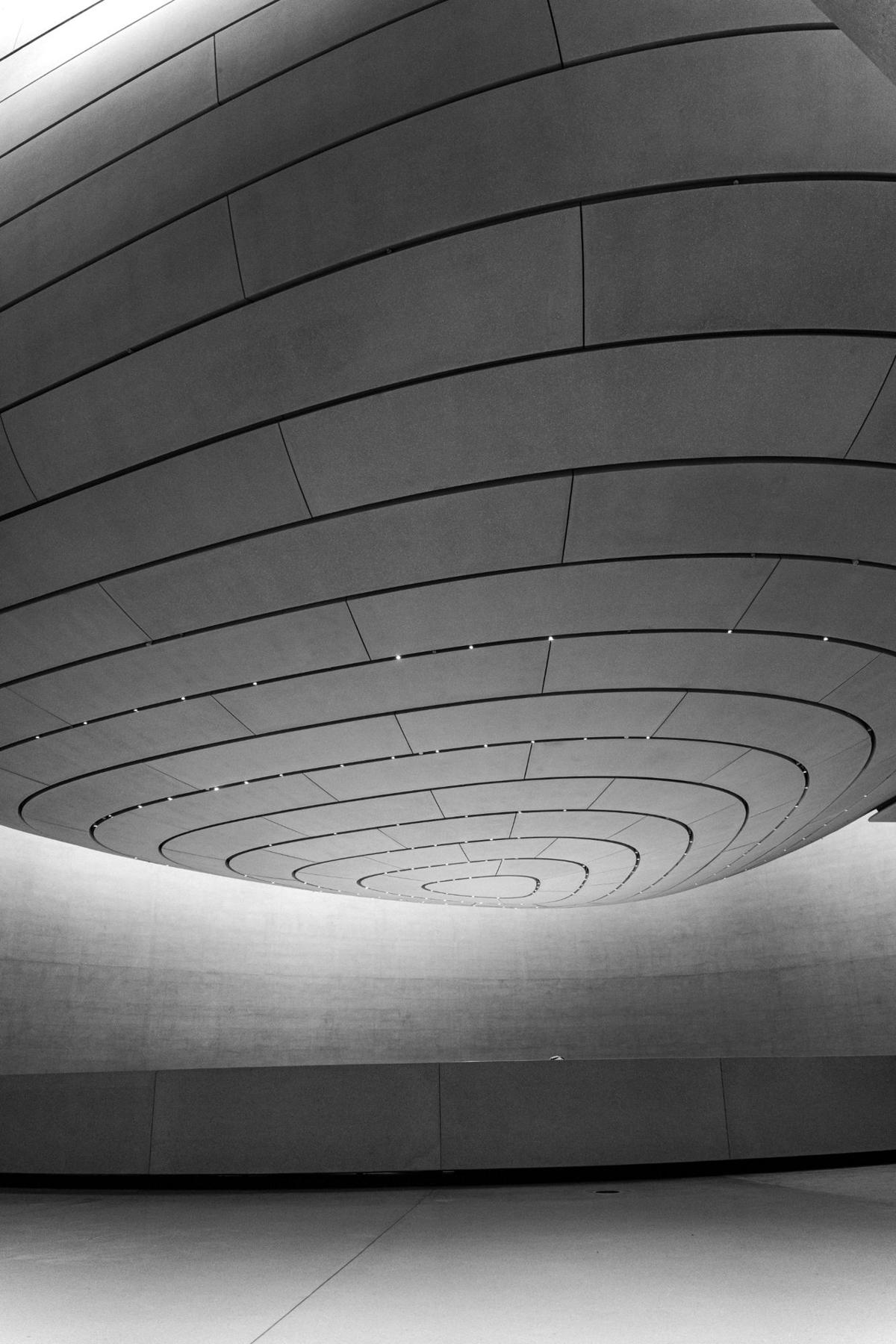 Plafond courbe à lignes concentriques ponctué de points lumineux